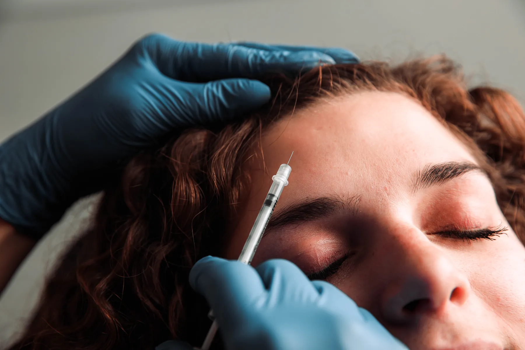 Neurotoxin Injections applied to woman's forehead in Belleville