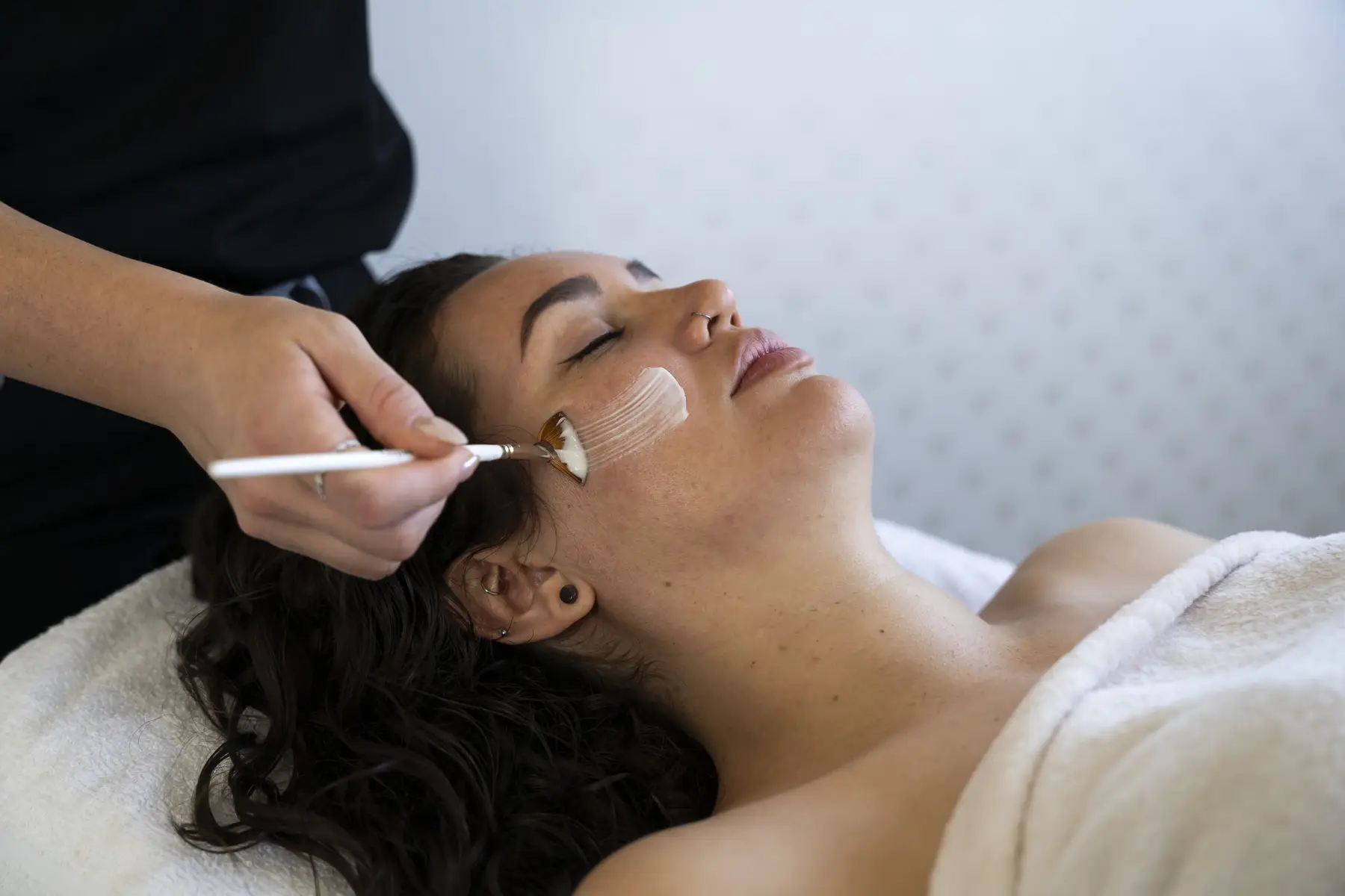 Personalized facial treatment being applied to woman