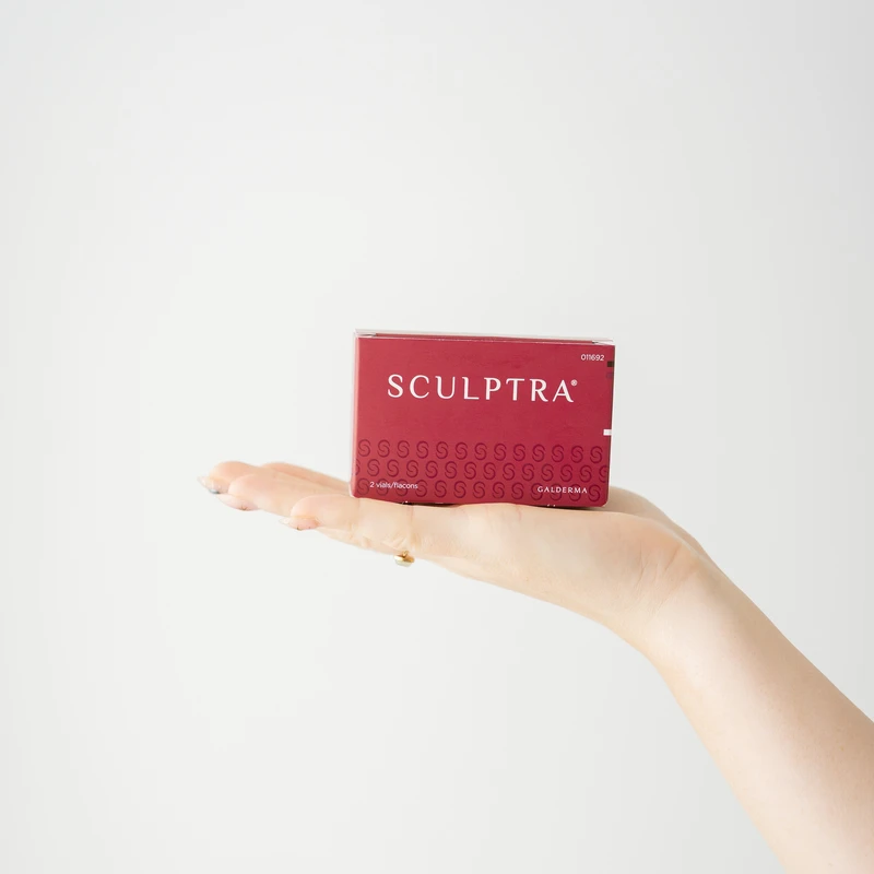 Hand presenting a Sculptra box used for collagen treatments in Belleville